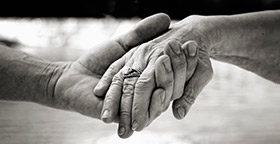 Close up of old couple holding hands